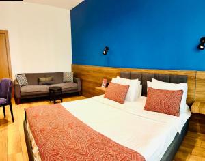 a bedroom with a large bed with a blue wall at Beşiktaş Konuk Evi Hotel in Istanbul
