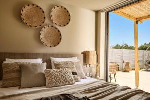a bedroom with a bed with plates on the wall at Villa Romas 3 by Villa Plus in Vasilikos +11 photos
