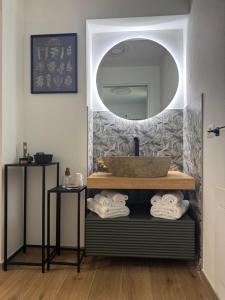 a bathroom with a sink and a mirror at Via delle Terme 71 - Casa vacanze in Salice Terme