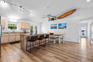 a kitchen and dining room with a table and chairs at Touch of Heaven in Pensacola Beach