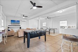 a living room with a ping pong table in it at Touch of Heaven in Pensacola Beach