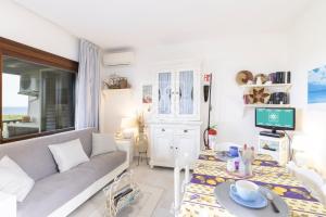 a living room with a couch and a table at Terrazza Celeste in Stintino