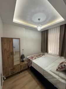 a bedroom with a large bed and a mirror at BDK hotel in Istanbul