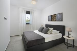een slaapkamer met een groot bed en een raam bij Villa Fasana-Apartment 1 by Vivi Rent in Fažana