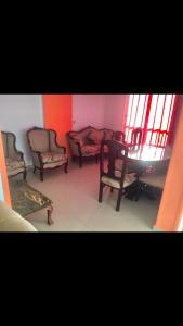 a room with chairs and a table and windows at Family holiday home beach view in Alexandria