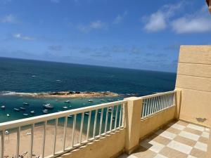 a balcony with a view of the ocean at Family holiday home beach view in Alexandria