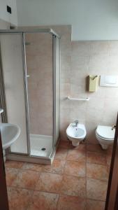 a bathroom with a shower and a toilet and a sink at Locanda Antica Bribano in Sedico