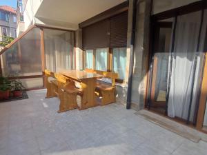 a wooden table sitting on a patio on a building at Апартамент РАЯ in Sozopol +7 photos
