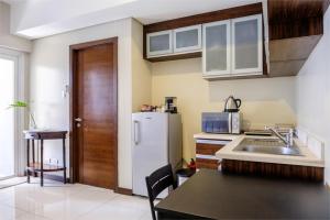 a kitchen with a white refrigerator and a sink at Luxury suite next to Shangrila and Westin Hotels in Manila