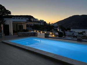 a large blue swimming pool on top of a house at Caldera Suites "Φάρος" in Galissas