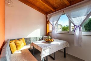 a room with a couch and a table and a window at Melek in Štivan