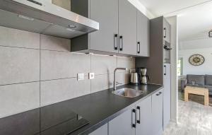 a kitchen with white cabinets and a sink at 3 Bedroom Gorgeous Home In Den Ham in Den Ham