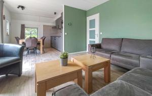 a living room with a couch and a table at 3 Bedroom Gorgeous Home In Den Ham in Den Ham +15 photos
