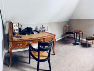 an office with a wooden desk and two chairs at Relais Guinguette in Tinténiac +63 photos
