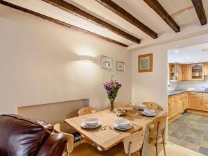 a kitchen and dining room with a wooden table and chairs at 3 Bed in Bowness-On-Windermere 93088 in Bowness-on-Windermere