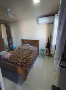 a bedroom with a leopard print bed in a room at Chalé com Piscina e Churrasqueira Privativos in Búzios +72 photos