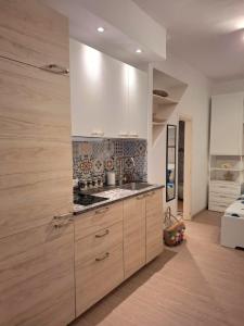 a kitchen with white cabinets and a counter top at La Casetta dei Paceri in Syracuse