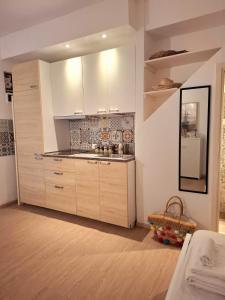 a kitchen with a sink and a refrigerator at La Casetta dei Paceri in Syracuse +29 photos