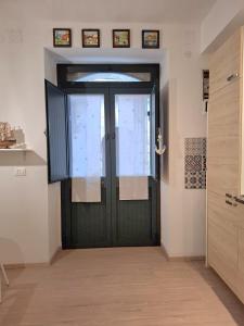 a black door in a white room with at La Casetta dei Paceri in Syracuse