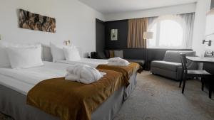 Voodi või voodid majutusasutuse Quality Hotel Royal Corner toas