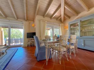a dining room with a table and chairs at Luxury Villa con Piscina & BBQ by Host Hero in Stintino