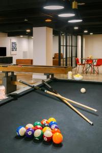 a pool table with cue balls and cue sticks on it at Global Luxury Suites at Georgetown in Washington, D.C.