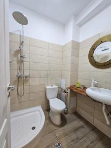a bathroom with a toilet and a sink at Sofia Residence in Constanţa