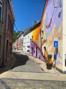 a street with a mural on the side of a building at Le gîte de Giulia in Dinant