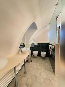 a bathroom with two sinks and two toilets at La Casa di Nadì in Matera +72 photos