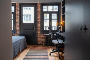 a bedroom with a bed and a desk with a chair at Cozy Urban 1BR Nest with Balcony Charm in Istanbul