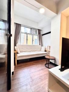 a living room with a couch and a window at Cozy & Quiet 1BR - Sai Ying Pun in Hong Kong