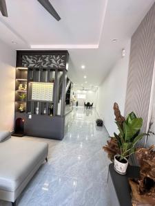a living room with a couch and a dog in the distance at Homestay Ăn Gì Cũng Được VT in Vung Tau