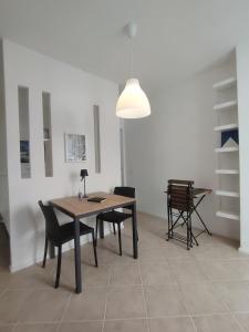 a dining room with a table and chairs and a lamp at Casa Polixeni - Da e Nònne in Carloforte +48 photos
