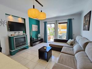 a living room with a couch and a tv at Cozy Ocean Park in Adeje +10 photos