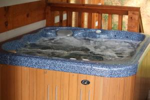 a jacuzzi tub filled with water in a room at View! Private! Hot Tub,Pool Table,Fireplace,RELAX! in Sevierville