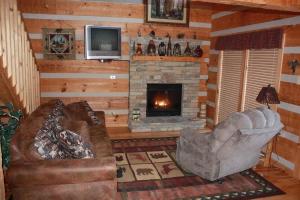 a living room with a couch and a fireplace at View! Private! Hot Tub,Pool Table,Fireplace,RELAX! in Sevierville +17 photos