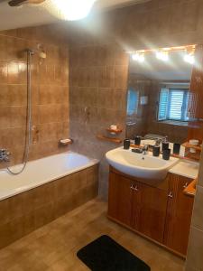 a bathroom with a tub and a sink and a shower at Countryhouse Gli Ulivi in Cossignano