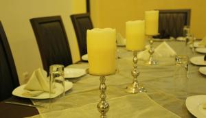 a table with three candles on top of it at GHS Hotel in Brazzaville