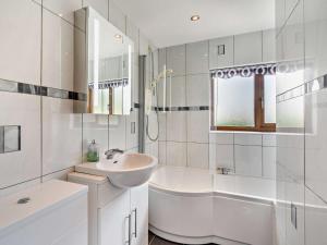 a white bathroom with a sink and a bath tub at 3 Bed in Uldale 95374 in Uldale +46 photos