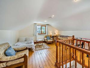 a living room with a couch and a staircase at 3 Bed in Uldale 95374 in Uldale