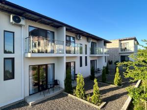 an exterior view of a house with a balcony at Cottages - Townhouses in Ureki