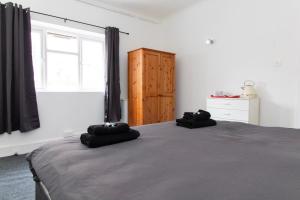 a bedroom with a bed and a window and a dresser at Pebbles Guest House Room 1 in Southampton