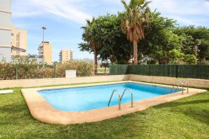 a swimming pool in the middle of a yard at Atico Piles in Piles