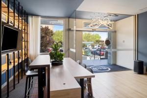 sala de estar con mesa de comedor y TV en B&B HOTEL Madrid Alcorcón, en Alcorcón