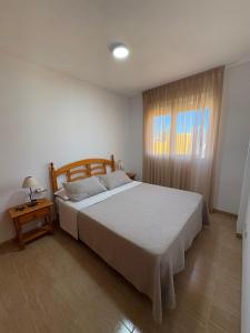 a bedroom with a large bed and a window at Alpen 1 Voramar Playa Norte in Peniscola +64 photos
