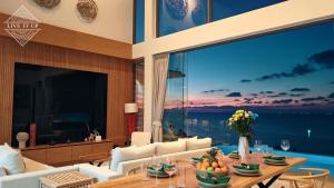 a living room with a view of the ocean at Santi Pura Villas in Koh Samui  +190 photos