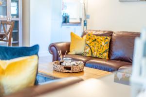 a living room with a couch and a coffee table at The Milking House - Llyn Peninsula in Nefyn