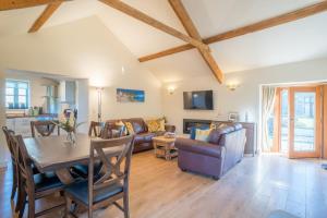 a living room with a table and a couch at The Milking House - Llyn Peninsula in Nefyn