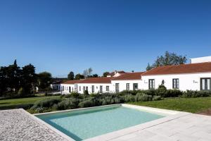 a swimming pool in the yard of a house at Casas de São José in Rio Maior
