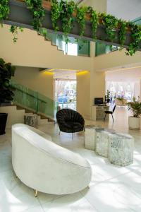a living room with a couch and a chair at HVH by Yaxché in Guadalajara